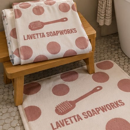 Branded shower curtain and bath mat on a bathroom stool